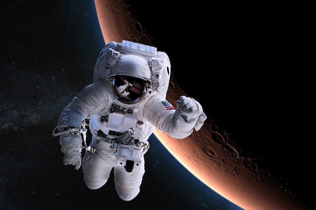 Astronaut in outer space on background of the Mars planet