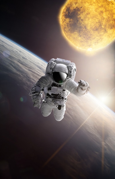 astronaut in outer space over the planet earth.stars provide the background.erforming a space above planet earth.sunrise,sunset.our home. iss.elements of this image furnished by nasa.