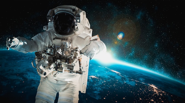 Astronaut spaceman does spacewalk while working for space station