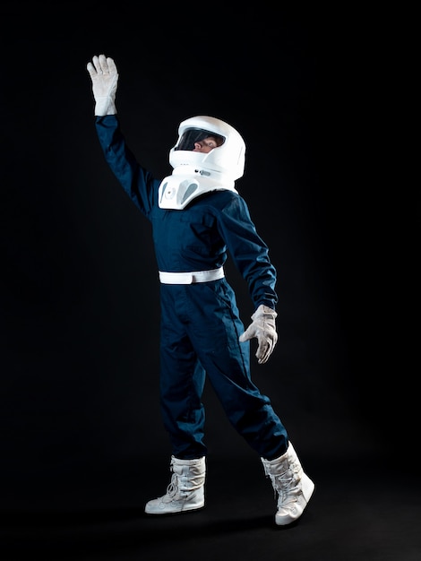 An astronaut in weightlessness reaches up with his hand