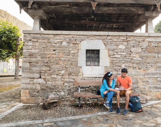 아스투리아의 역사적인 건물 빌라누에바 유산 혼혈 부부는 태블릿과 함께 야외에 있습니다.