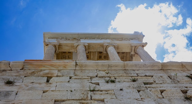 Athens greece propylaea and temple of athena nike in the acropolis monumental gate blue cloudy sky in spring sunny day