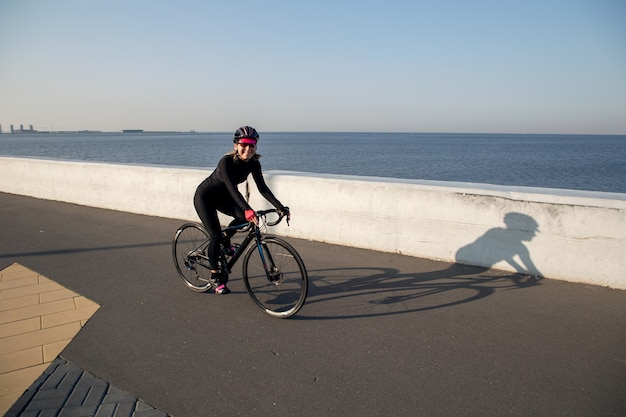 Athlete cycling on the waterfront