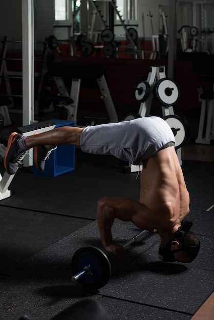 Athlete Exercising PushUps On Barbell In Elevation Mask