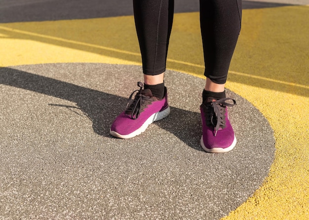 Athlete feet in sneakers Woman doing sport outdoors Healthy lifestyle training concept