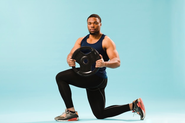 Athlete in gym outfit holding weights