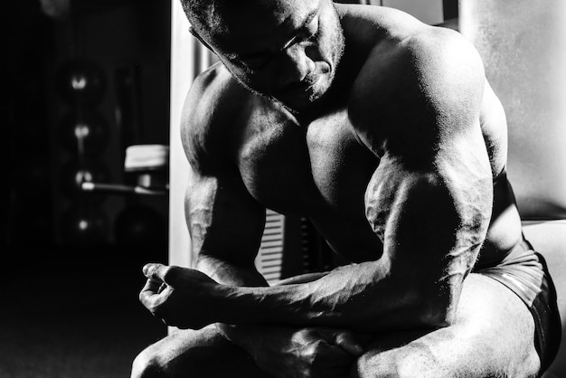 The athlete in the gym sitting on the bench