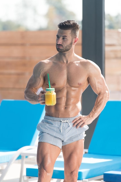 Athlete Holding a Glass of Orange Juice