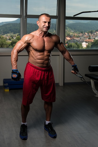 Athlete Is Working On His Chest With Cable Crossover In Gym