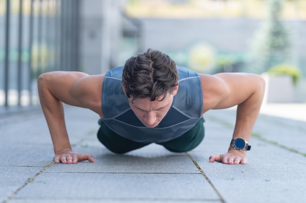 Athlete man do pushups outdoorathlete man do pushups outside athlete man do pushups