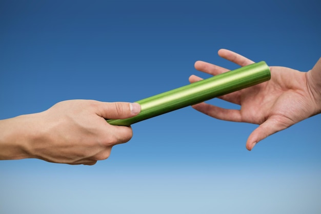 Athlete passing a baton to the partner