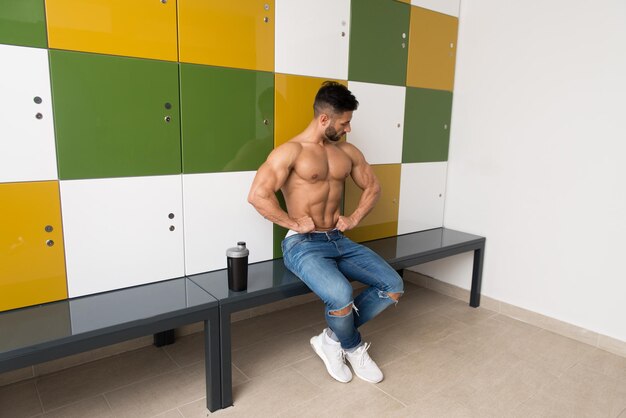 Athlete Resting on Lounger With Supplements and Shaker