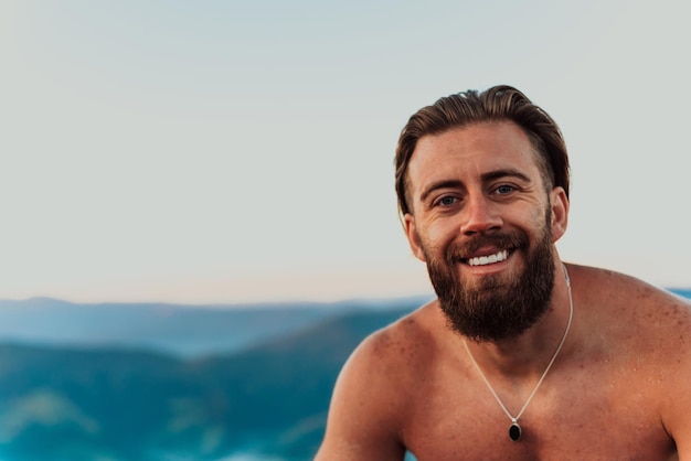 An athlete rests on top of a mountain after exhausting running training.