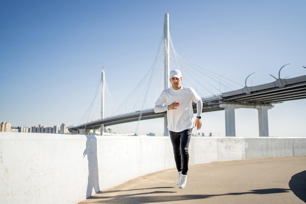 Athlete running man conducts fitness training on the street in the city Healthy lifestyle