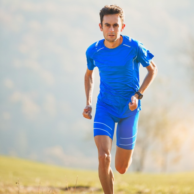 Athlete running in the mountains of the Italian national team in training