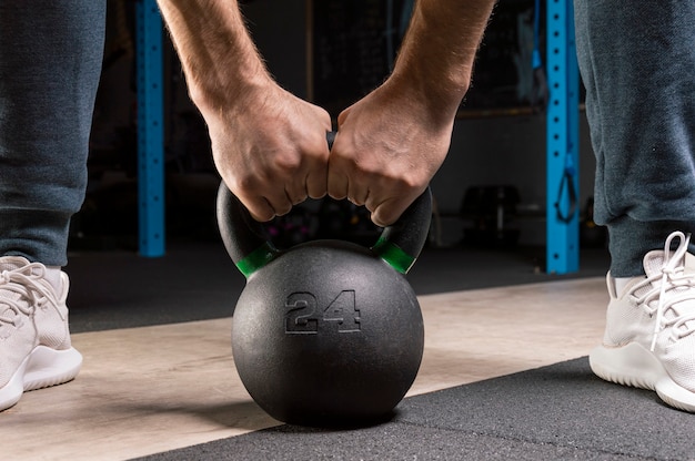   athlete's hands holding a heavy weight.    