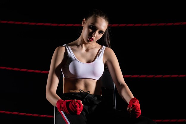 The athlete sits in a chair in the boxing ring after losing the fight Despite the technical preparation the athlete lost the fight