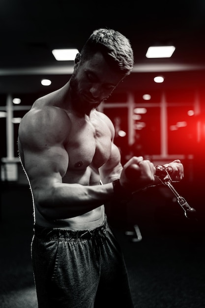 Athlete strong sporty bodybuilder Handsome muscular man posing in the gym