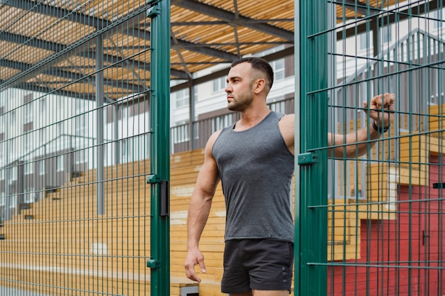 Athlete training in the open air. Workout on the playground.