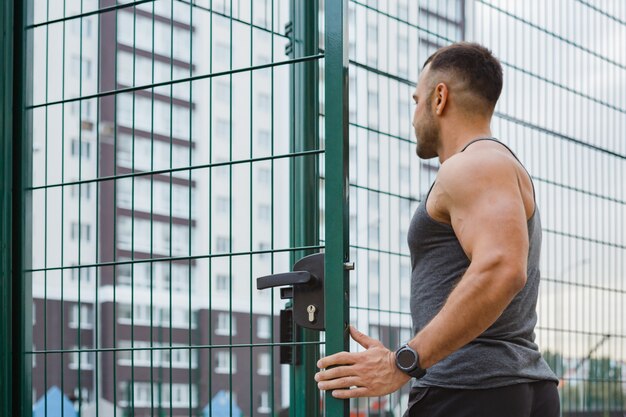 Athlete training in the open air. Workout on the playground.