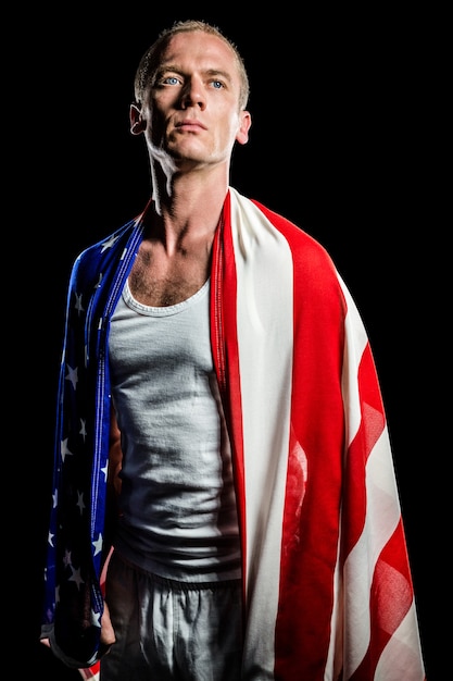 Athlete with american flag wrapped around his body