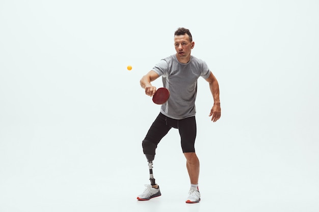 Athlete with disabilities or amputee isolated on white studio background. Disabled sport and healthy lifestyle concept.