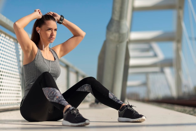 Athlete woman tying up hair before a run