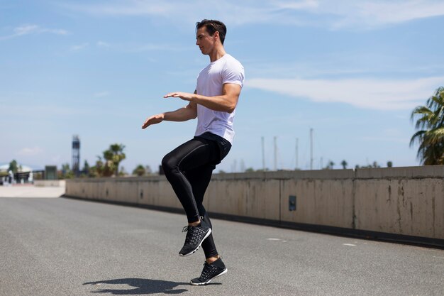 Athlete working out on cross fit jump outside