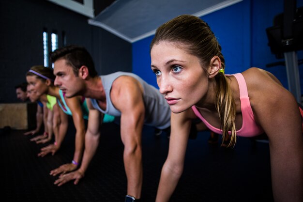 Athletes doing push-ups in gym