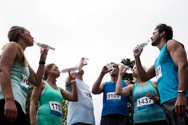 Athletes drinking water in park