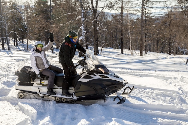 Athletes on a snowmobile.