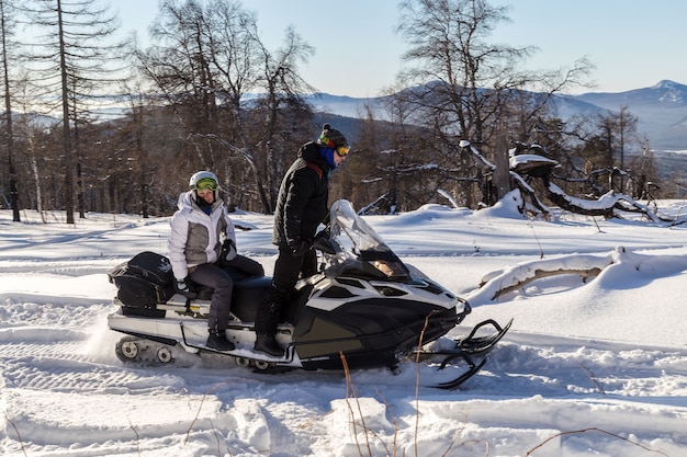 Athletes on a snowmobile.