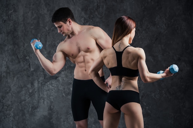 Athletic beautiful sexy young couple posing in studio