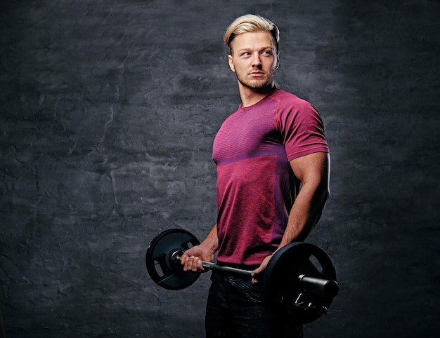 Athletic blond male doing a biceps workout with a barbell.