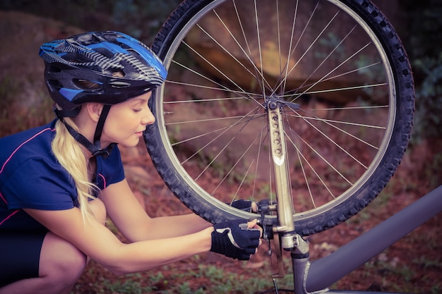 Athletic blonde checking her mountain bike