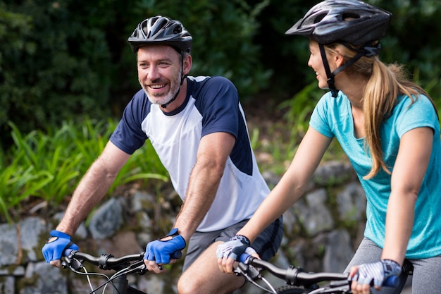 Athletic couple cycling on the open road