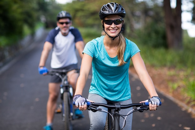 Athletic couple cycling on the open road