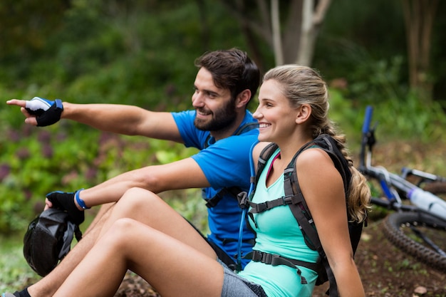 Athletic couple pointing at nature