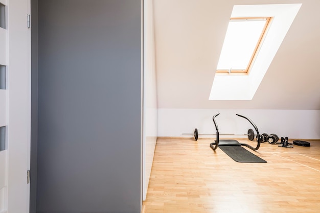 Athletic equipment on wooden floor in home gym interior in the a