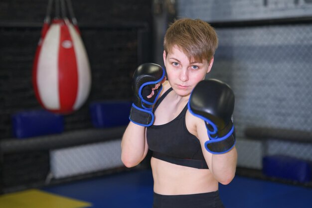 Athletic girl is boxing young woman having box training fighting Healthy sport lifestyle concept