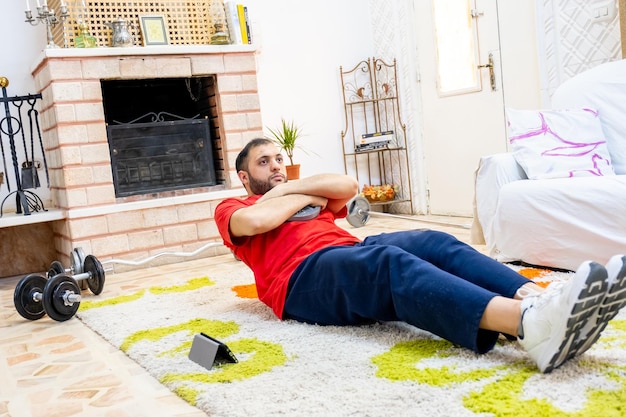 Athletic guy playing aerobic at home