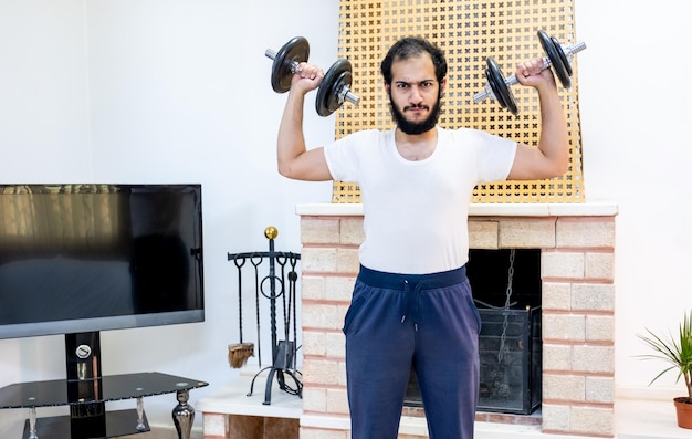 Athletic guy training hard at his home