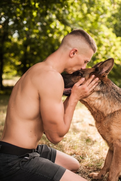 athletic guy with a German Shepherd