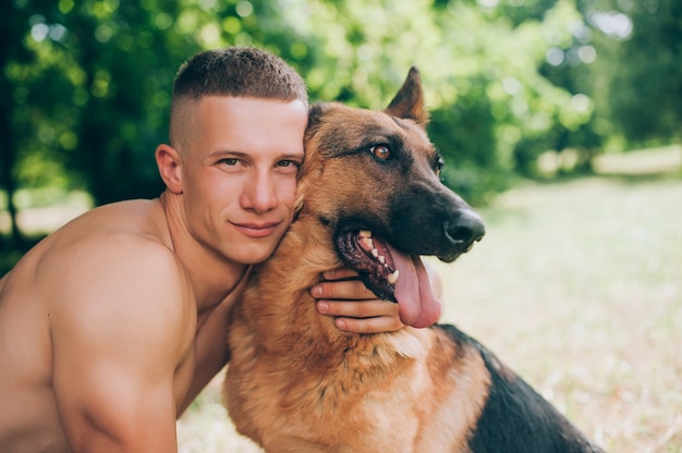 athletic guy with a German Shepherd