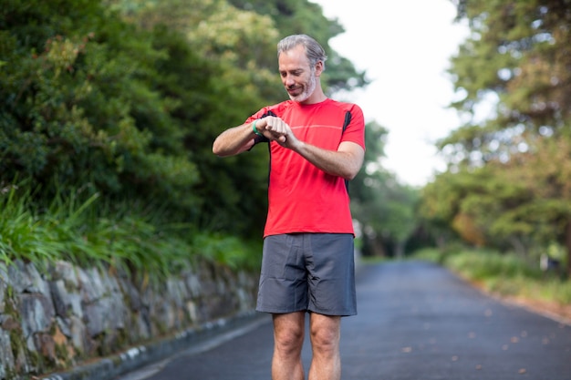 Athletic man checking time on wristwatch