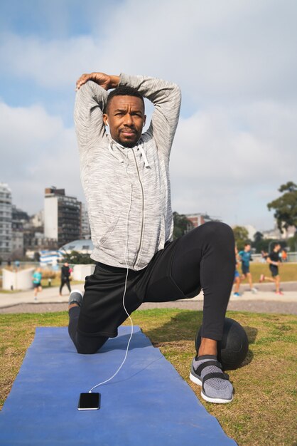 Athletic man doing exercise at the park.