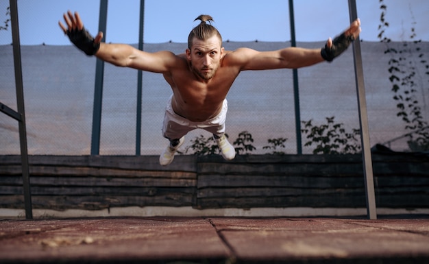 Athletic man doing push-up exercise with jumps