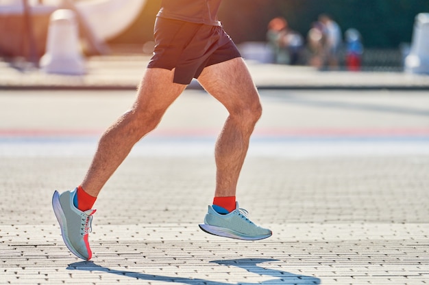 Athletic man jogging in sportswear in the city