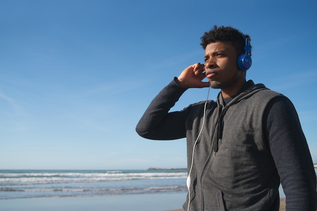 Athletic man listening to music