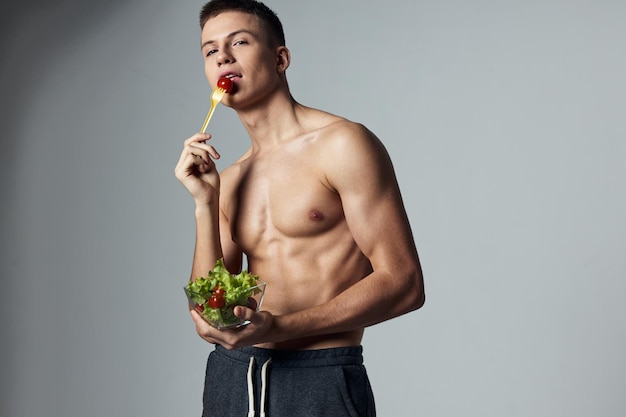 Athletic man muscular torso plate salad healthy food workout